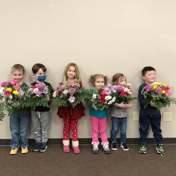 Kids holding flowers
